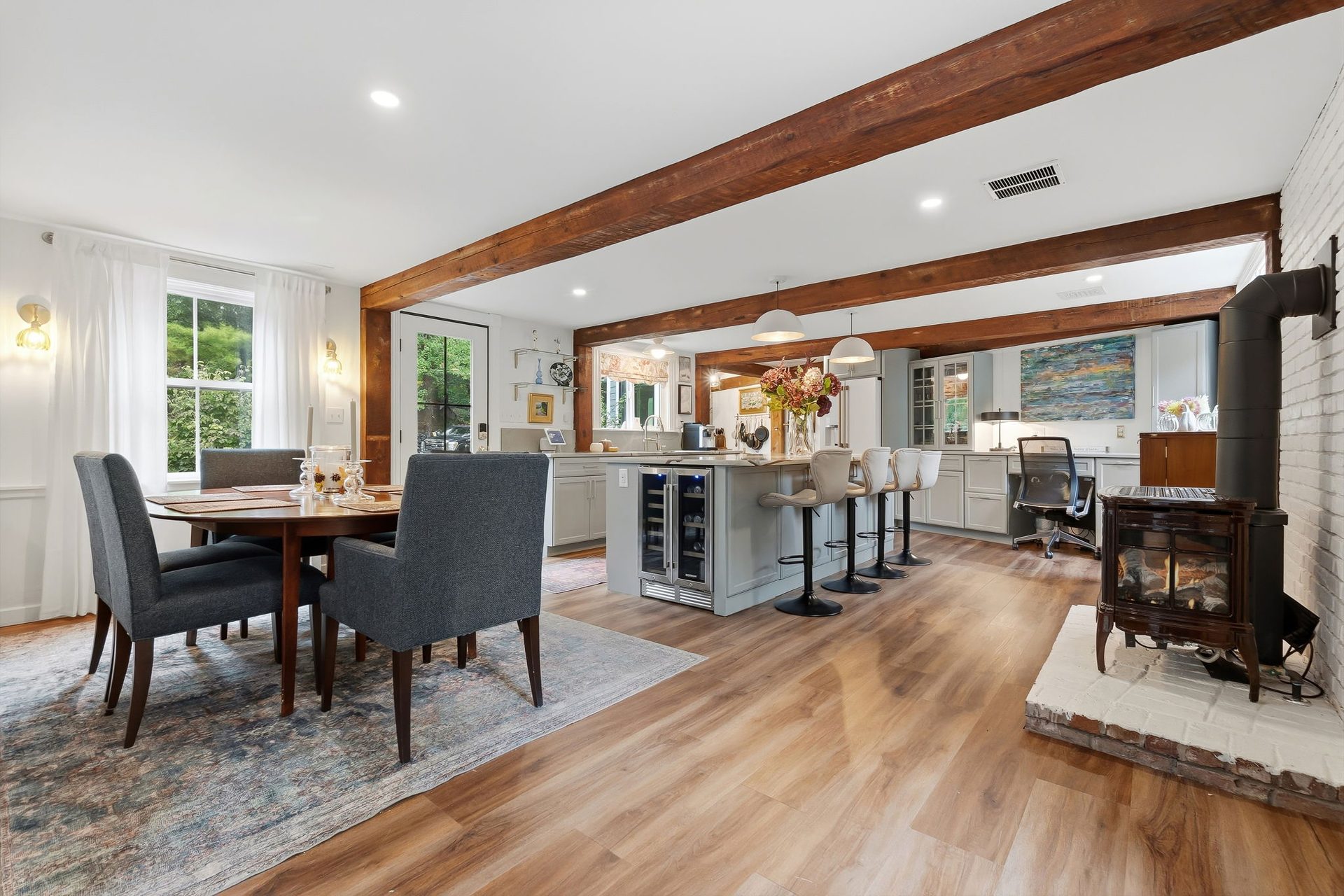 The dining area with the gas stove at right and the kitchen beyond